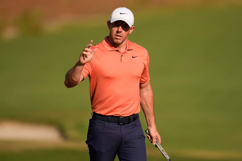 Rory McIlroy, of Northern Ireland, waves after making a putt on the 15th hole during the...