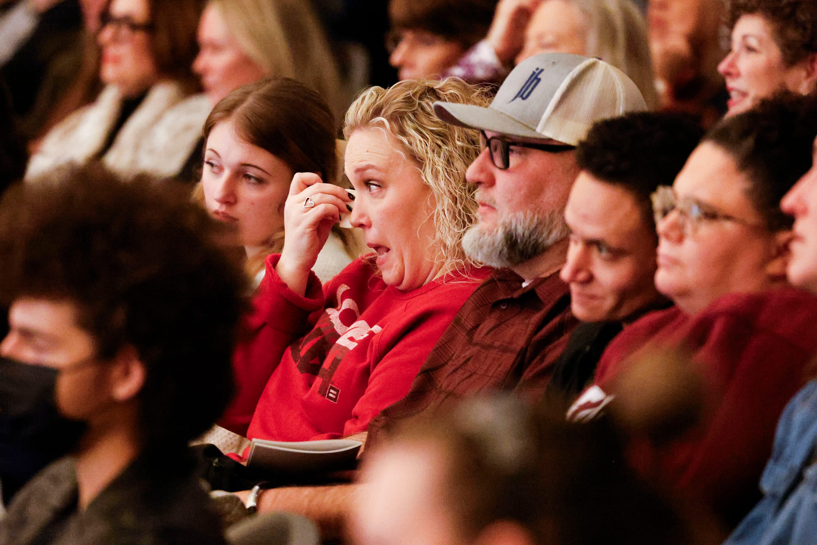 Amy Hightower, sitting by her husband Phillip Hightower, gets emotional she watches her son...