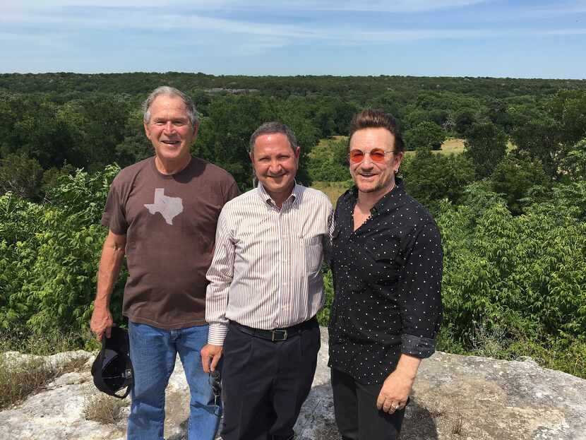 Ken Hersh (center) with former President George W. Bush (left) and singer-activist Bono at...