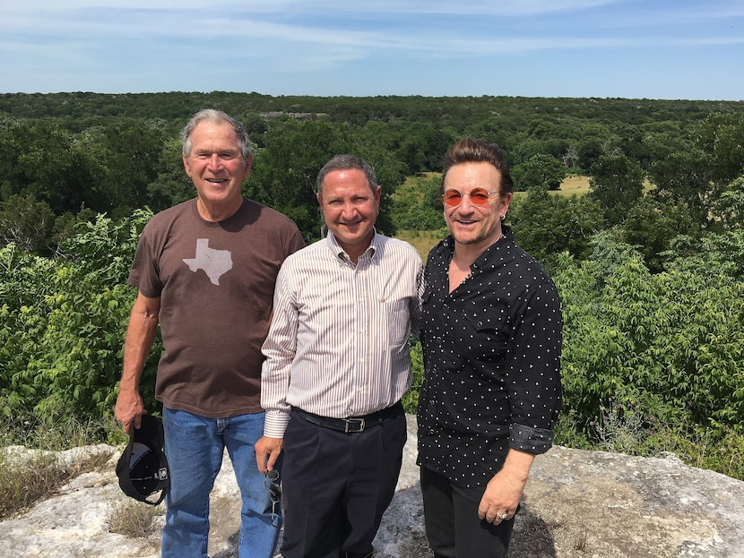 Ken Hersh (center) with former President George W. Bush (left) and singer-activist Bono at...