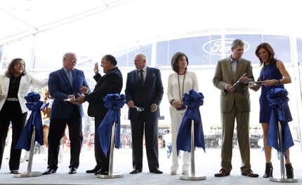 Representatives from Ford, Dallas Cowboys, City of Frisco and Frisco ISD celebrate after...