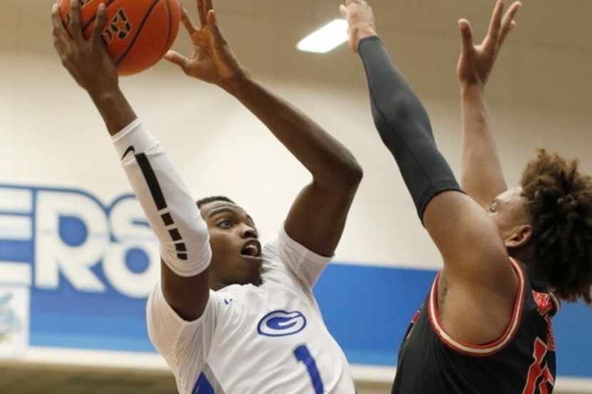Grand Prairie's Jaylin Jackson-Posey (1) skies to the basket against the defense of South...