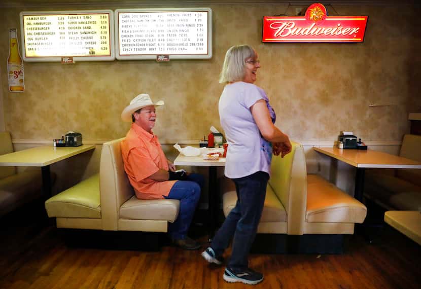 Candace Warden shares a laugh with diner Danny McDonald at Green's Sausage House in...