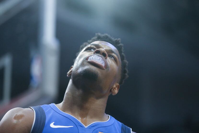 Dallas Mavericks guard Dennis Smith Jr. (1) reacts after Luka Doncic failed to catch his...