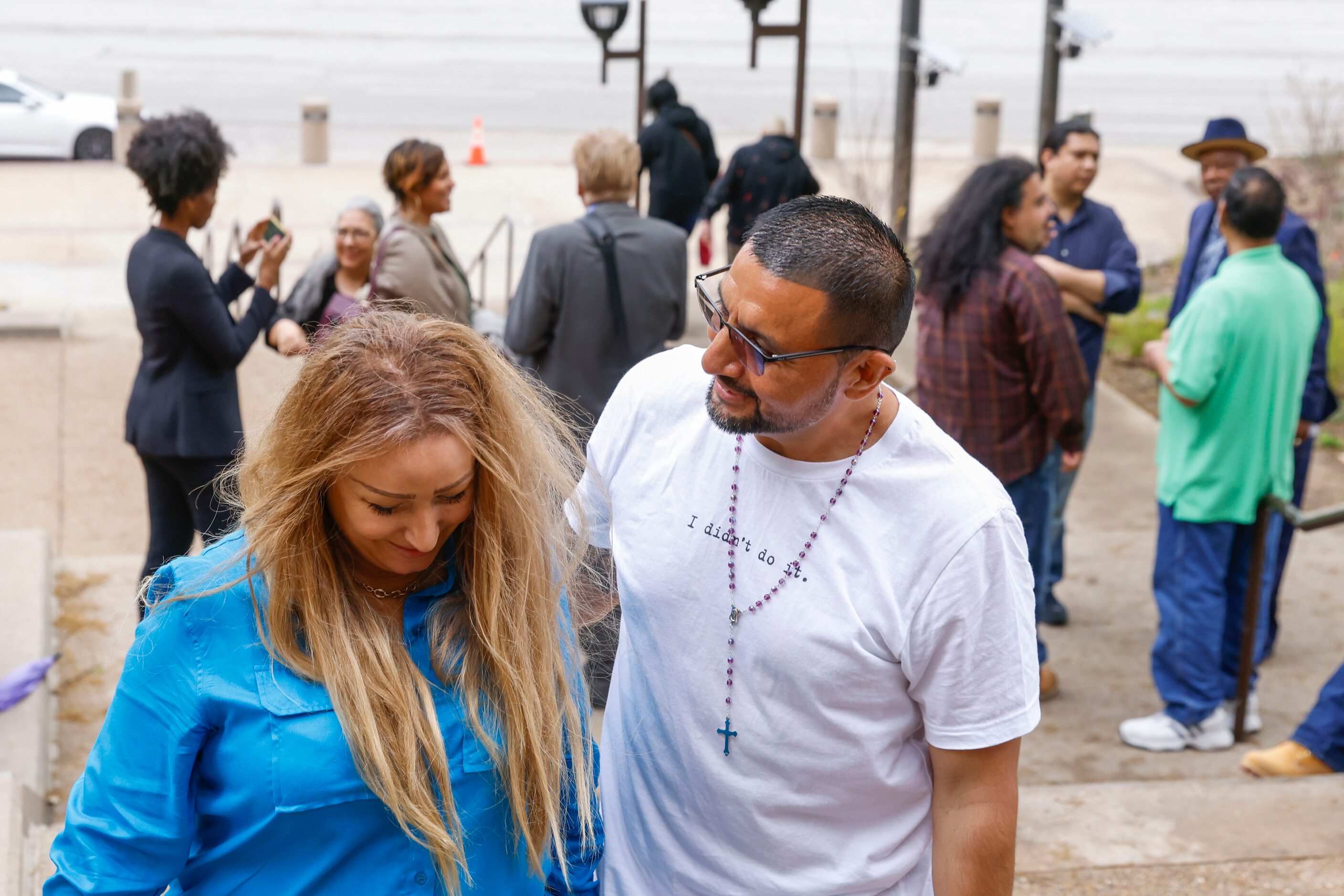 Martin Santillan (center) shares a moment with his long time friend Angie Bell while leaving...