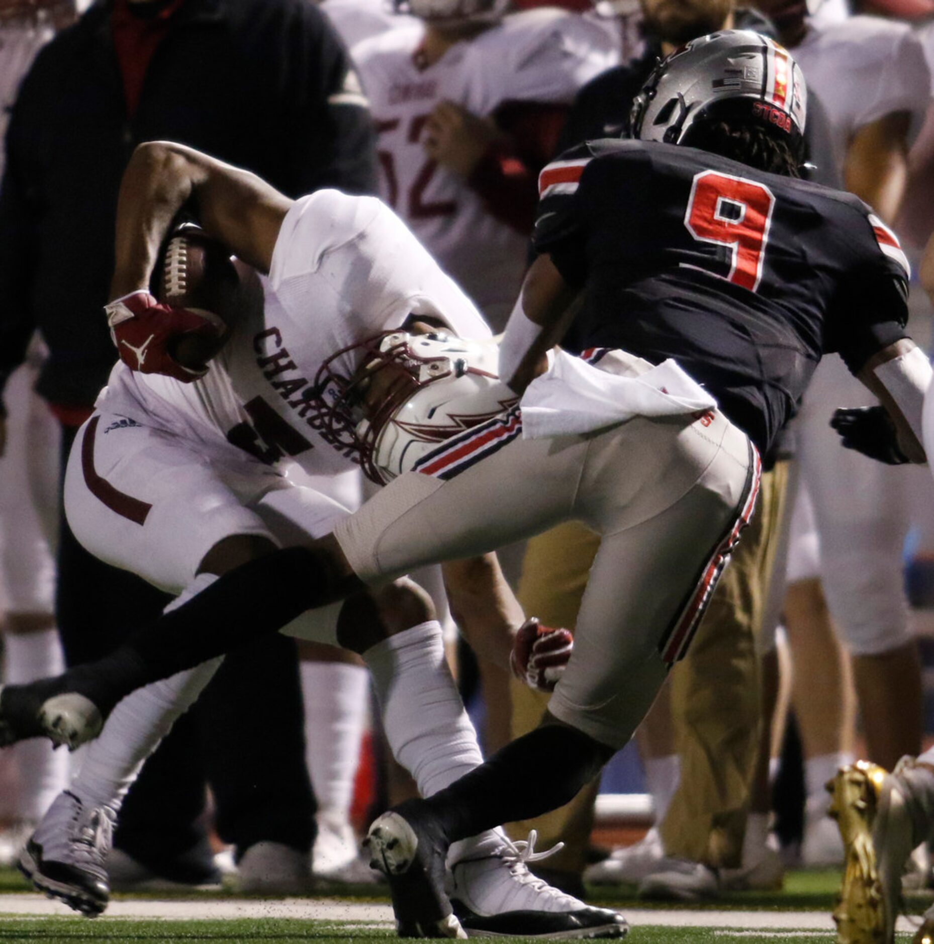 Keller Central receiver D.J. Graham (5) is pulled down by Flower Mound Marcus defensive back...