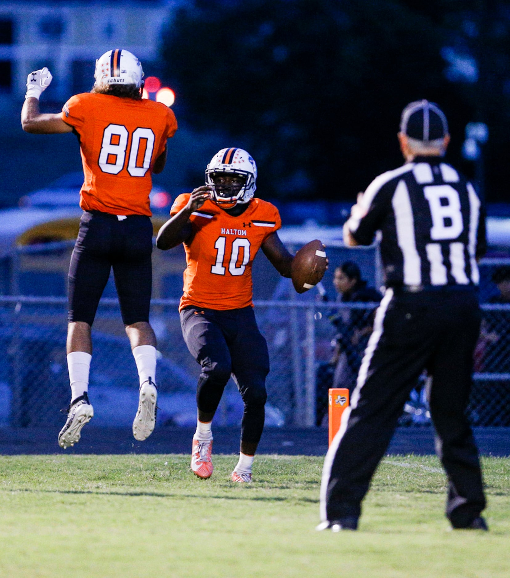 TXHSFB Haltom City senior quarterback Adam Hill (10) is congratulated by junior wide...