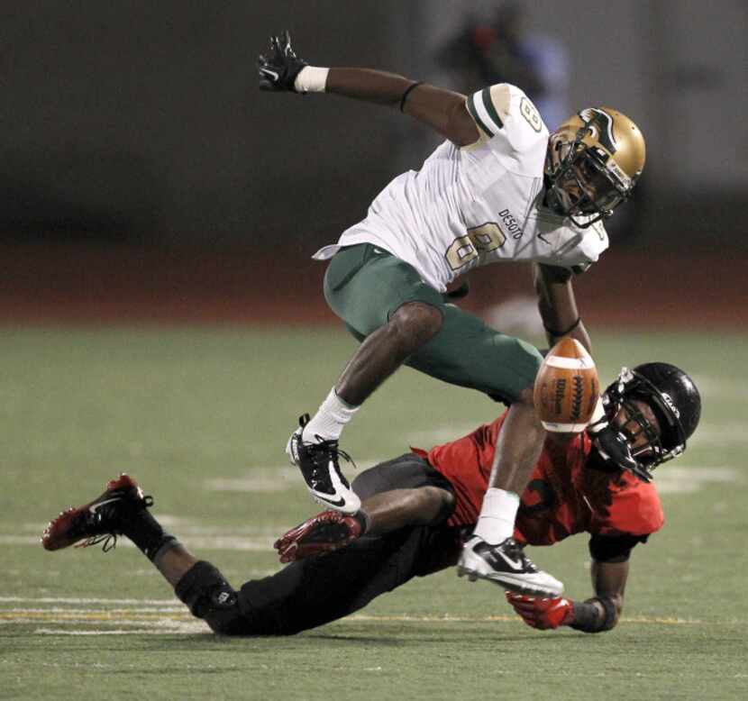 Trinity Trojans defensive back Dany Mulanga (2)  forces a fumble by DeSoto Eagles' WR Akile...