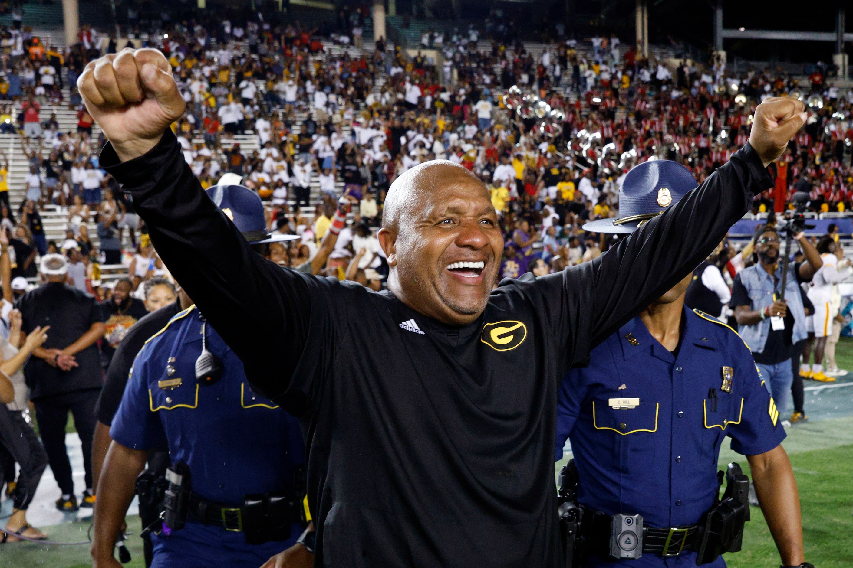 Grambling State head coach Hue Jackson raises his arms after winning the State Fair Classic...