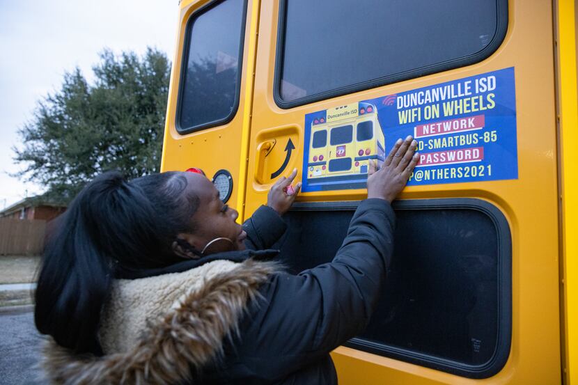 Duncanville ISD bus driver Stephanie Brown posts the network name and password on the...