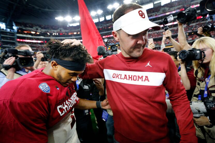 Oklahoma Sooners quarterback Kyler Murray (left) is congratulated by head coach Lincoln...