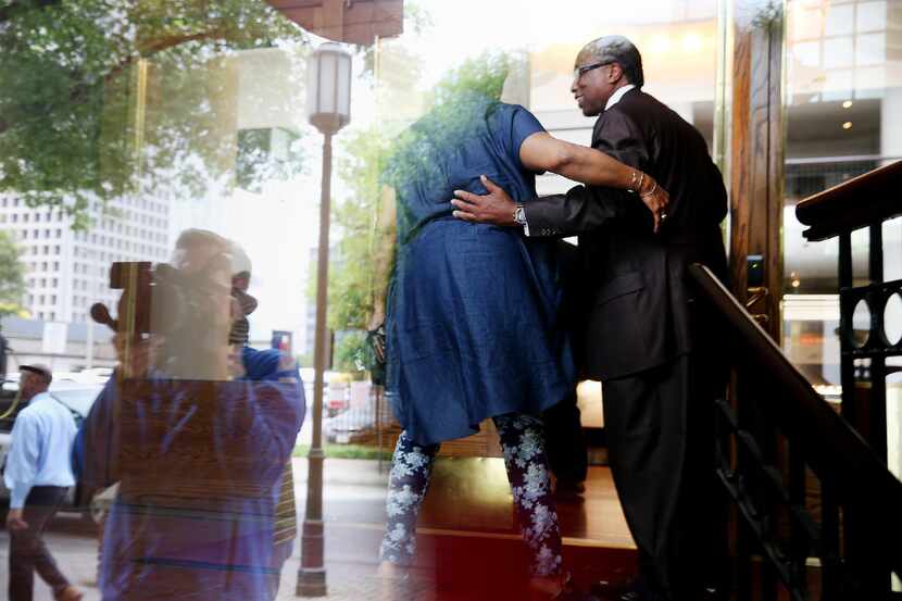 Dallas County Commissioner John Wiley Price is greeted after entering Founders Square...