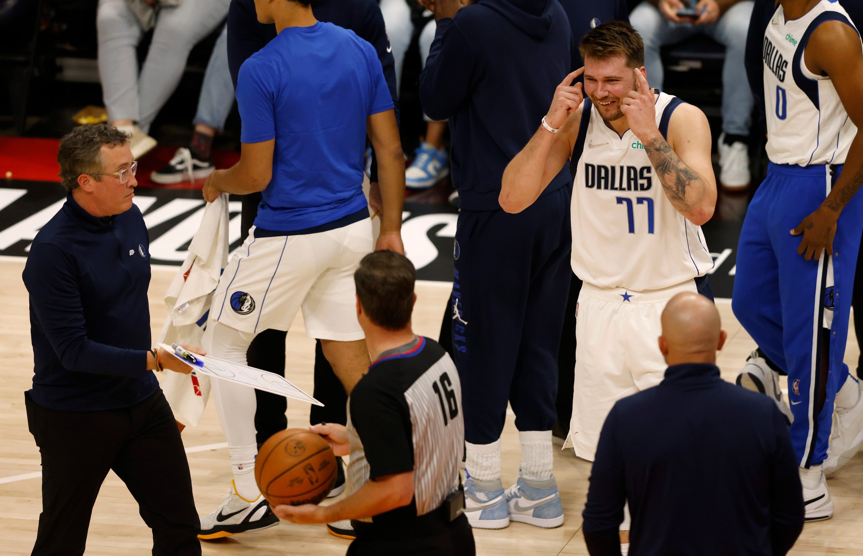 Dallas Mavericks guard Luka Doncic (77) talks with referee David Guthrie (16) after a...