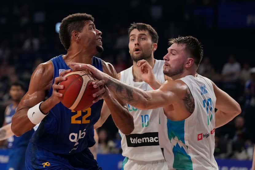 Slovenia guard Luka Doncic (77) blocks Cape Verde center Edy Tavares (22) trying to shoot in...