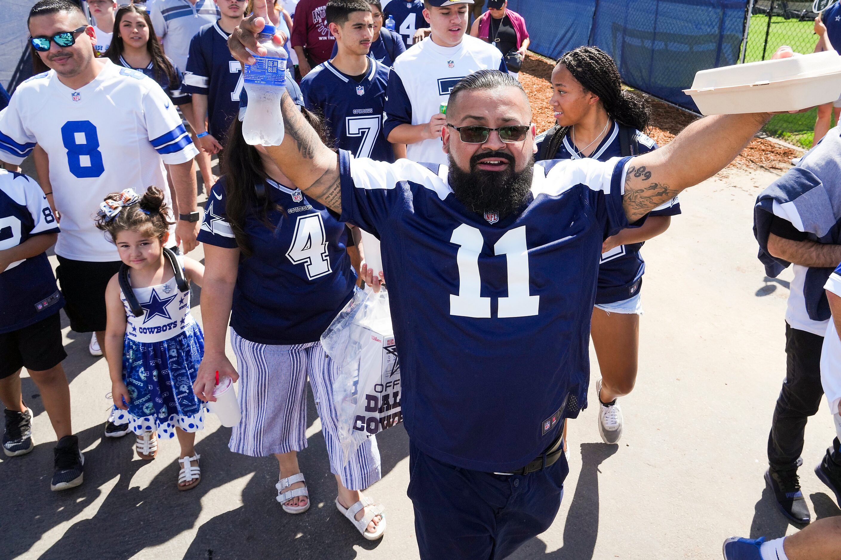 Dallas Cowboys fan Jose Gonzalez celebrates after being one of the first ones through the...