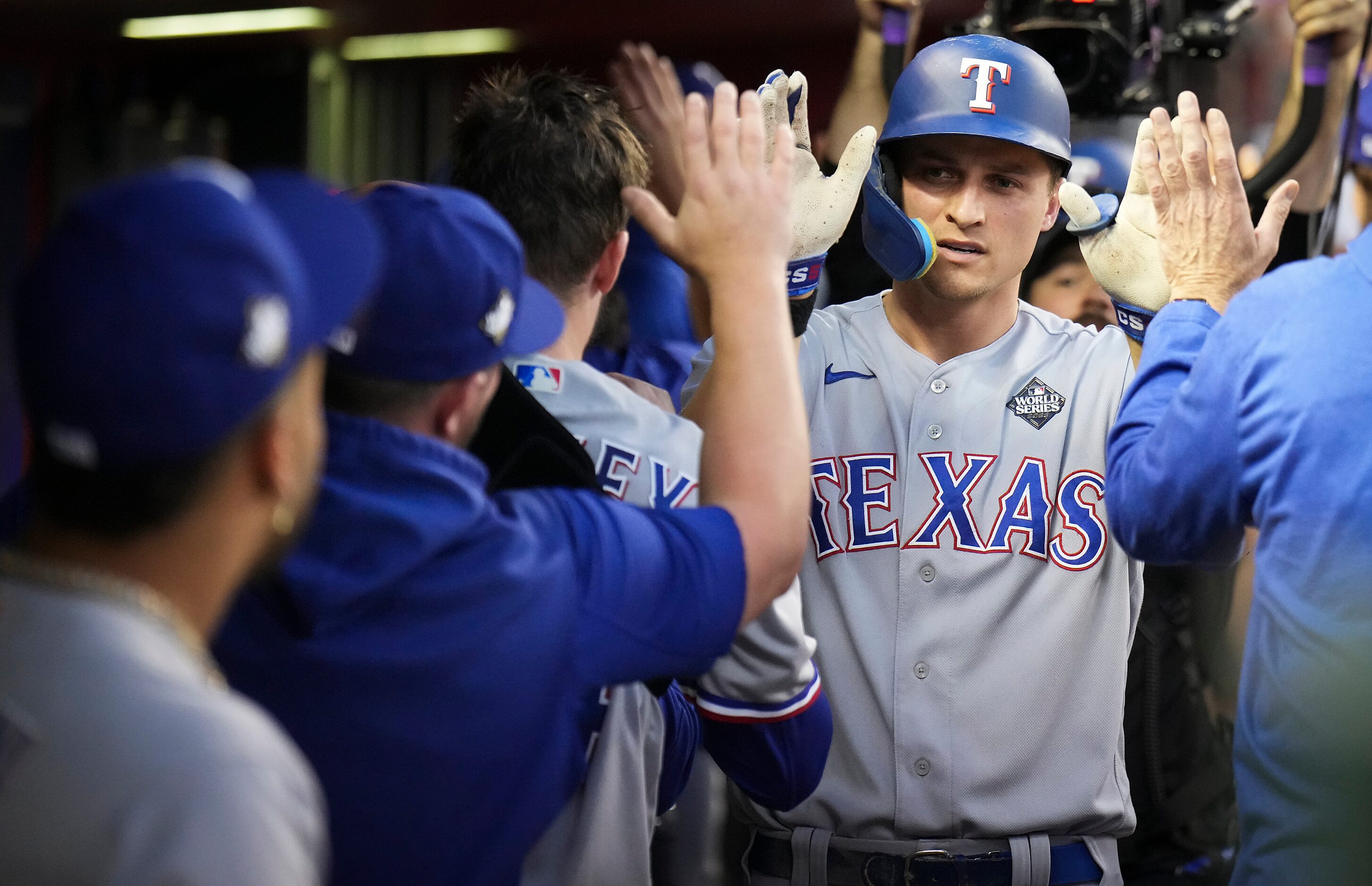 Texas Rangers shortstop Corey Seager celebrates in the dugout after hitting a solo home run...