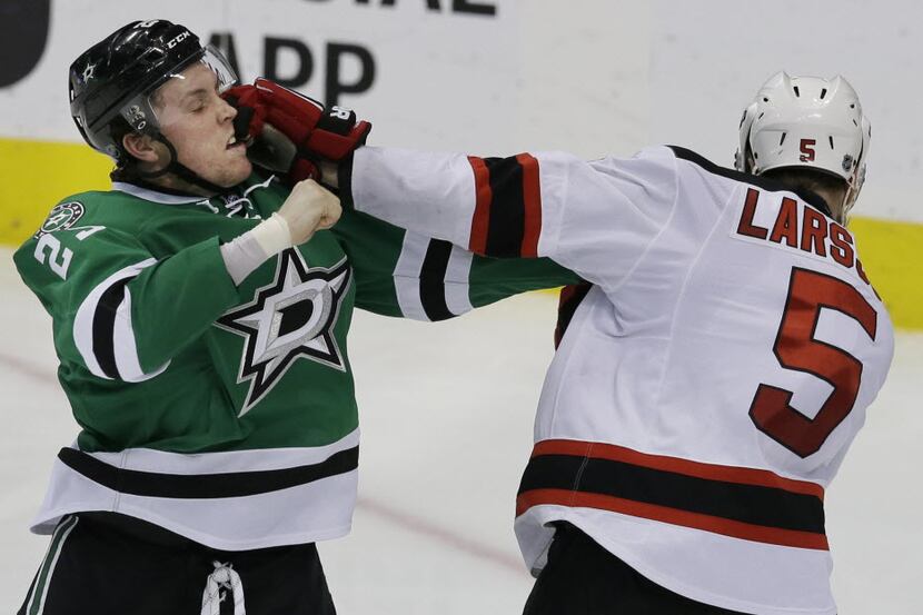New Jersey Devils Adam Larsson (5) and Dallas Stars Brett Ritchie (25) tangle during the...