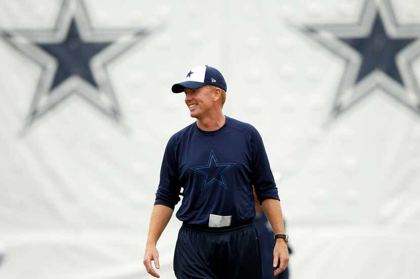 Dallas Cowboys head coach Jason Garrett smiles as the team stretches during the afternoon...