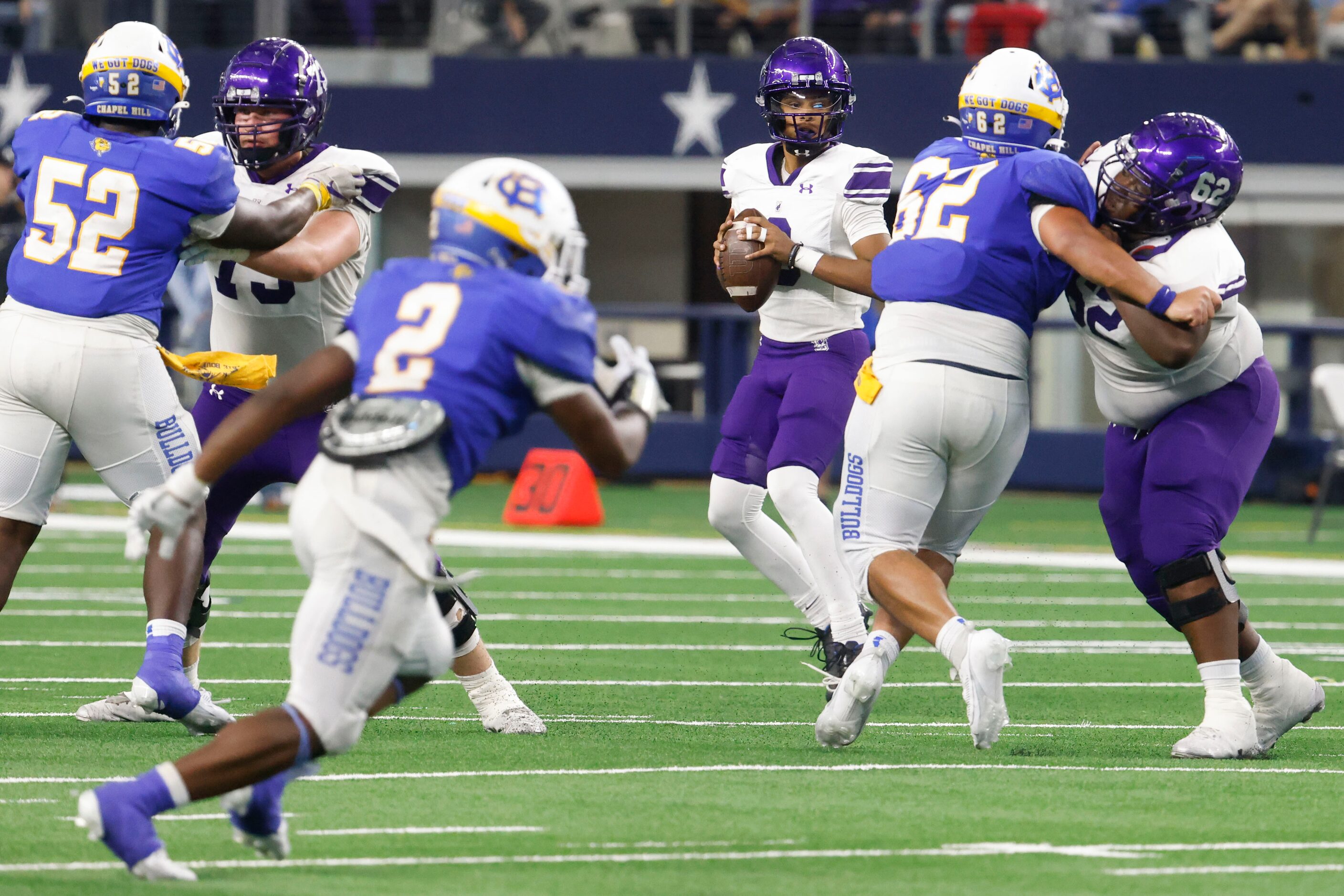 Anna high’s QB Ziondre Williams (center) looks to throw against Tyler Chapel Hill during the...