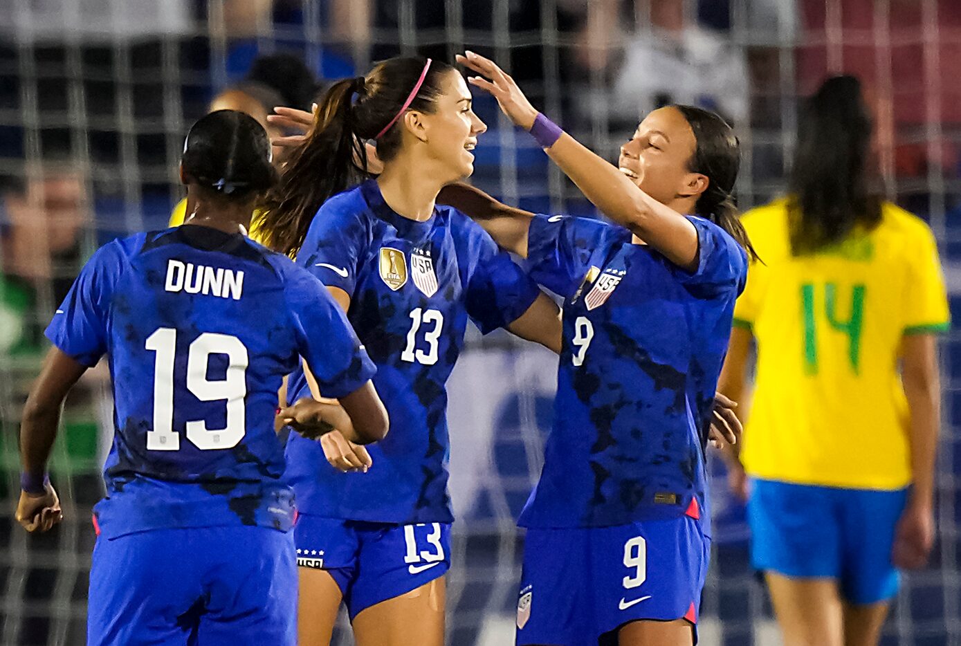 United States forward Alex Morgan (13) celebrates with forward Mallory Swanson (9) and...