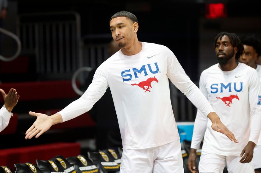 Southern Methodist Mustangs forward Tristan Clark (25) receives a hand slap from fans...