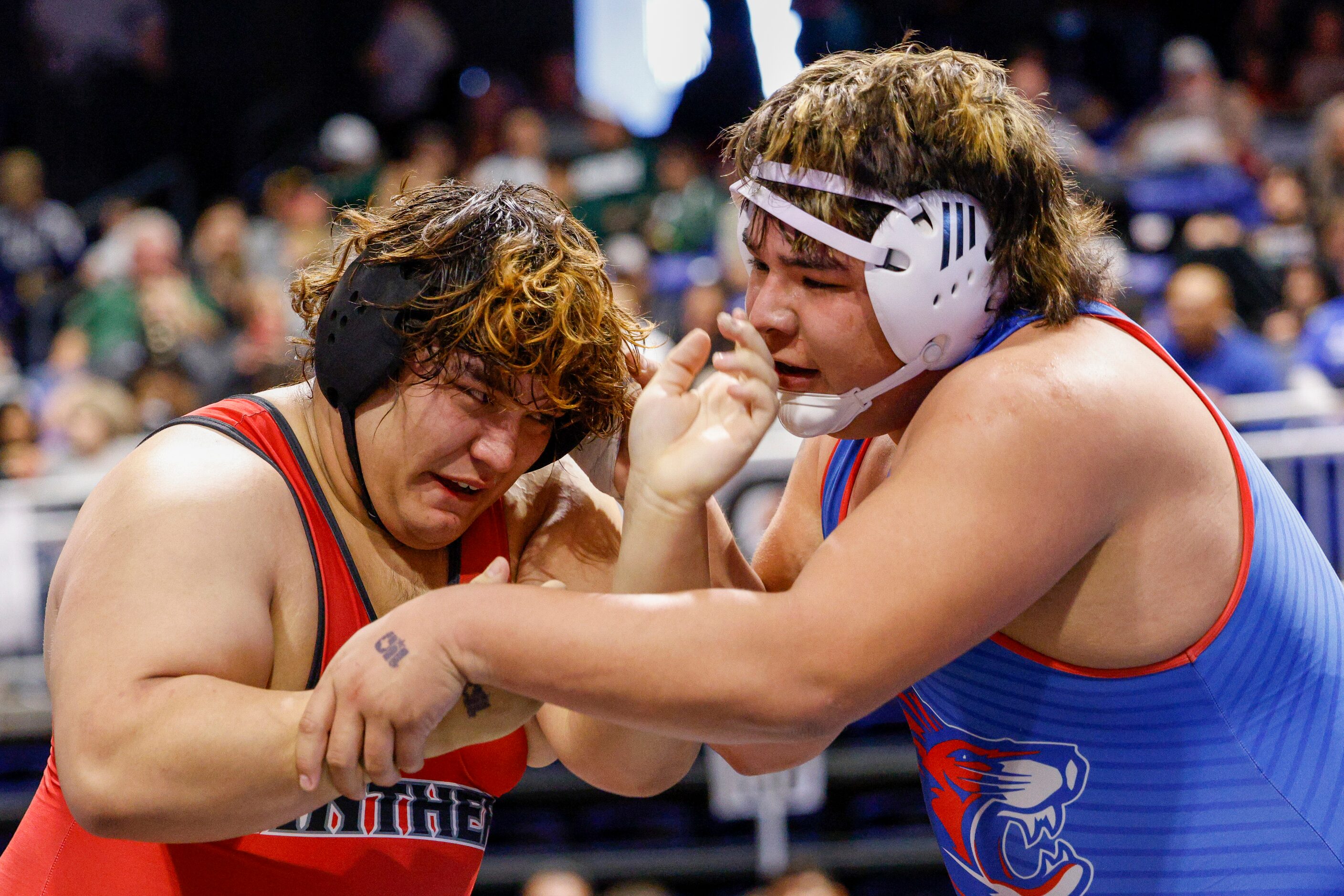 Americo Fuentes of Hillcrest wrestles Phillip Saenz of Leander during a quarterfinal match...