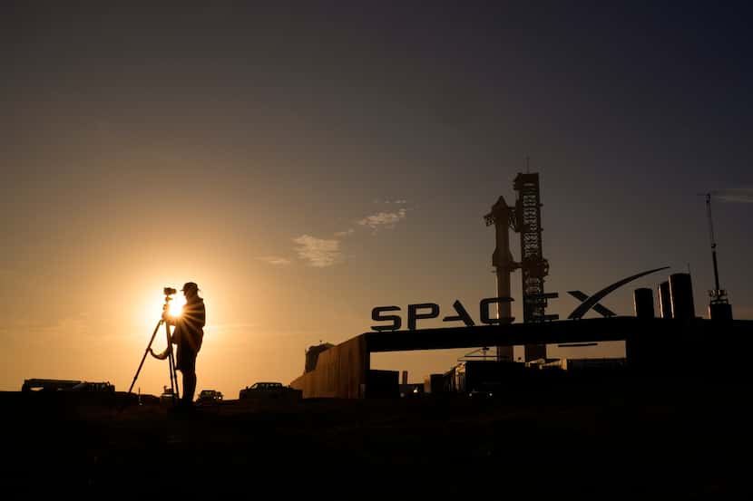 A photographer prepares to take photos of SpaceX's mega rocket Starship as it is prepared...