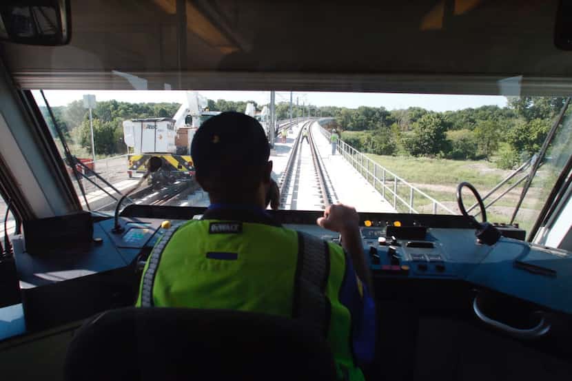 DART rail operator Jerome Watts, operates the first live wire test on the Blue Line...