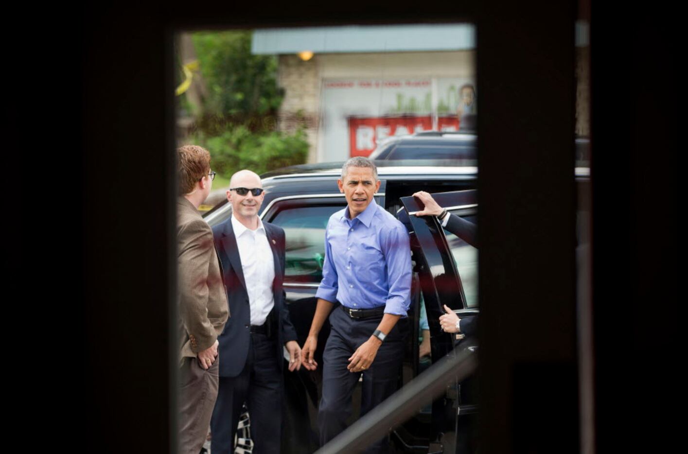President Barack Obama steps out of his vehicle to make an unannounced stop at Torchy's...
