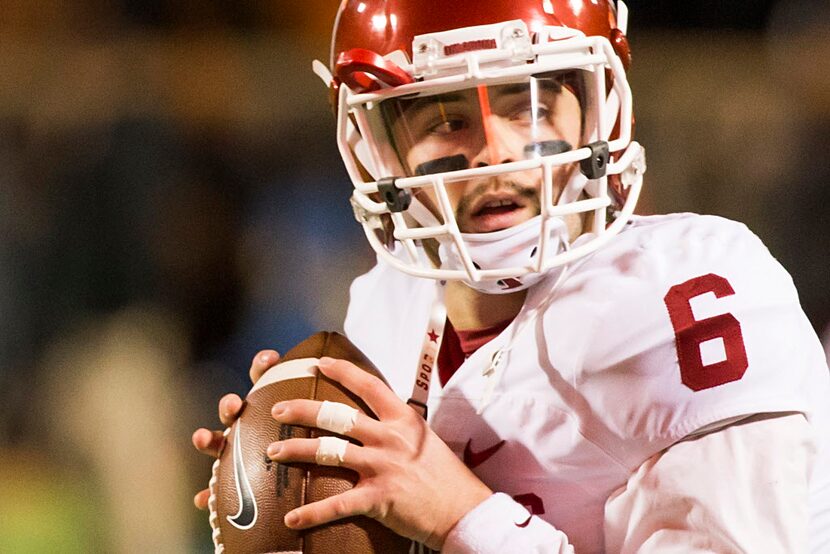 Oklahoma quarterback Baker Mayfield warms up before an NCAA football game against Oklahoma...