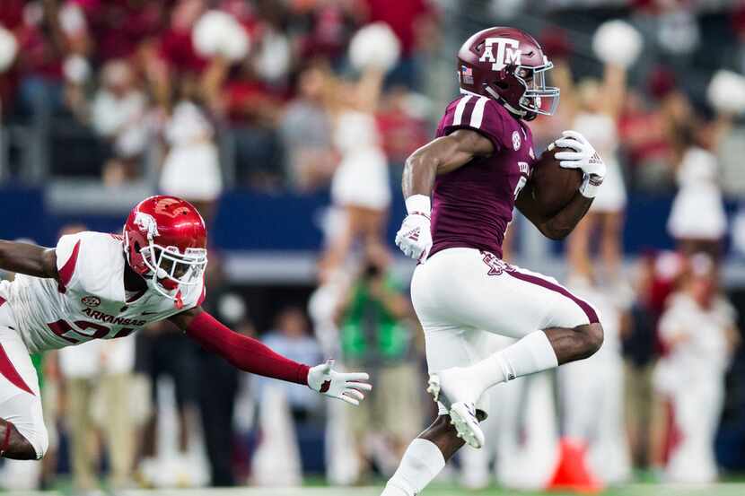 Texas A&M Aggies running back Jashaun Corbin (7) escapes a tackle by Arkansas Razorbacks...