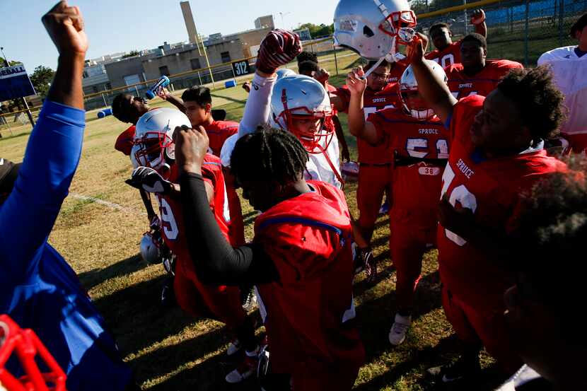 Spruce High School football players break out of huddle during football practice on...