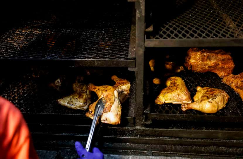 Ernestine Edmond of Mama E's BBQ and Home Cooking checks on the meat at her restaurant in...