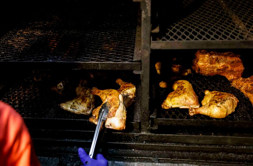 Ernestine Edmond of Mama E's BBQ and Home Cooking checks on the meat at her restaurant in...