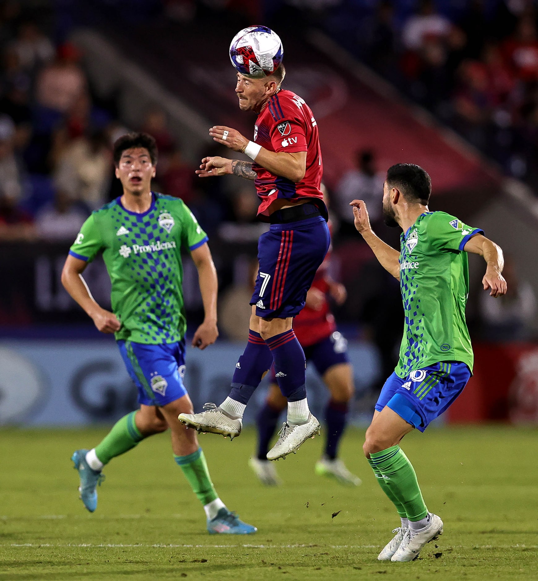 FC Dallas attacker Paul Arriola (7) heads the ball against Seattle during the first half in...