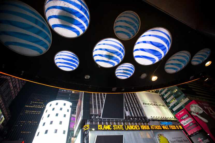 AT&T Inc. signage is displayed at the company's store in the Times Square area of New York,...