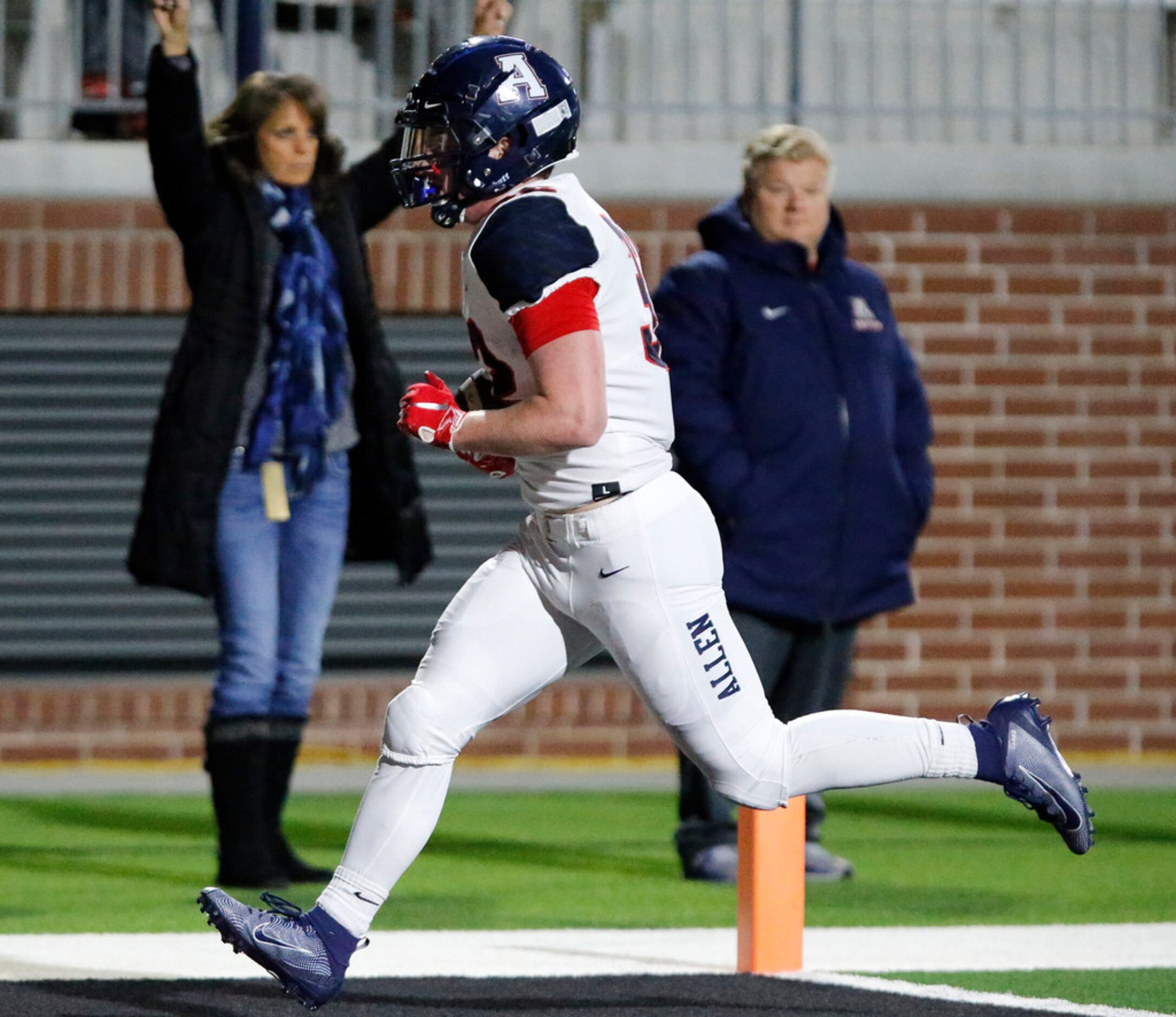 Allen High School running back Justin Hall (32) runs across the goal line after catching a...