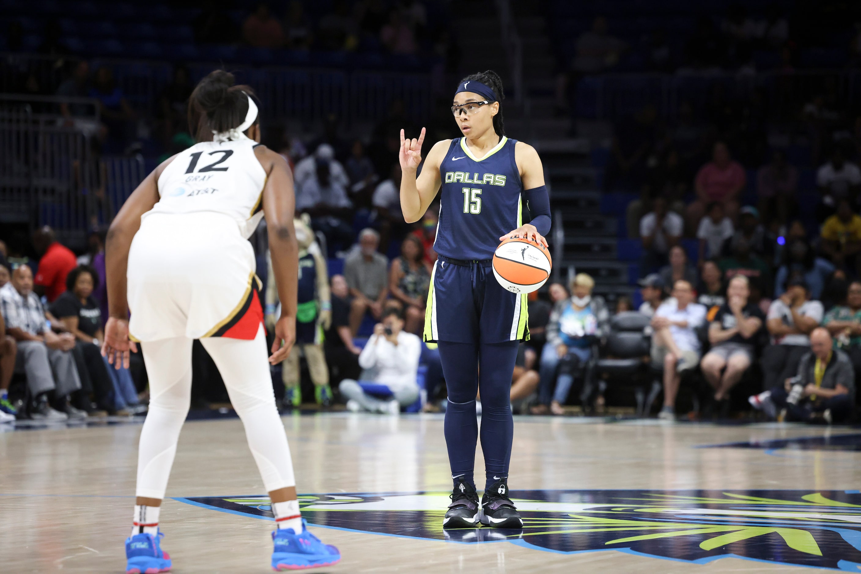 Dallas Wings guard Allisha Gray (15) signals to teammates before driving the ball into...