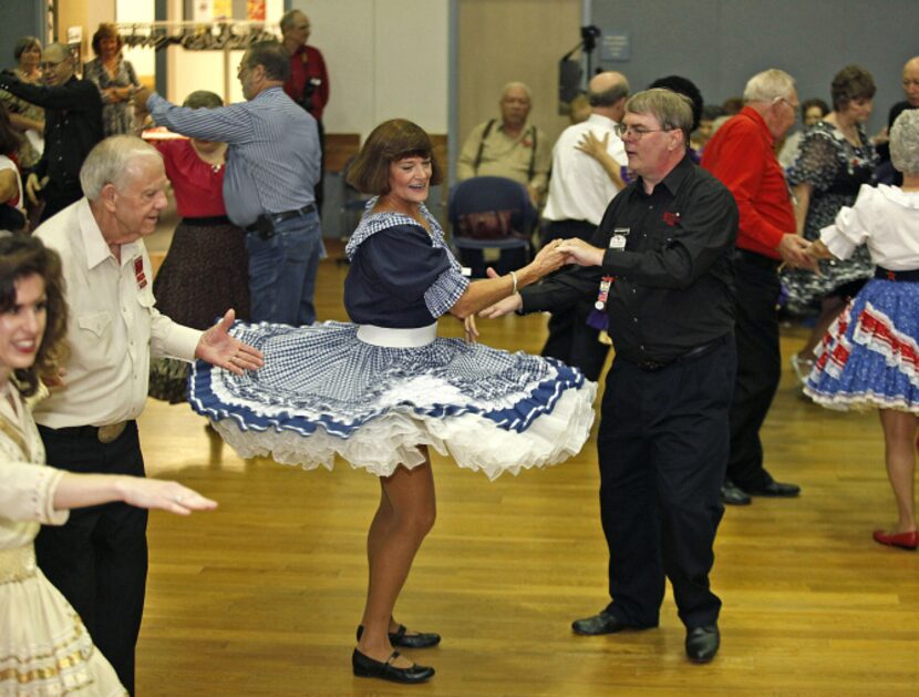 Nancy Barr, 55, takes a turn with Bill Knight, 57, of Dallas, at Octoberfeast, a reunion and...