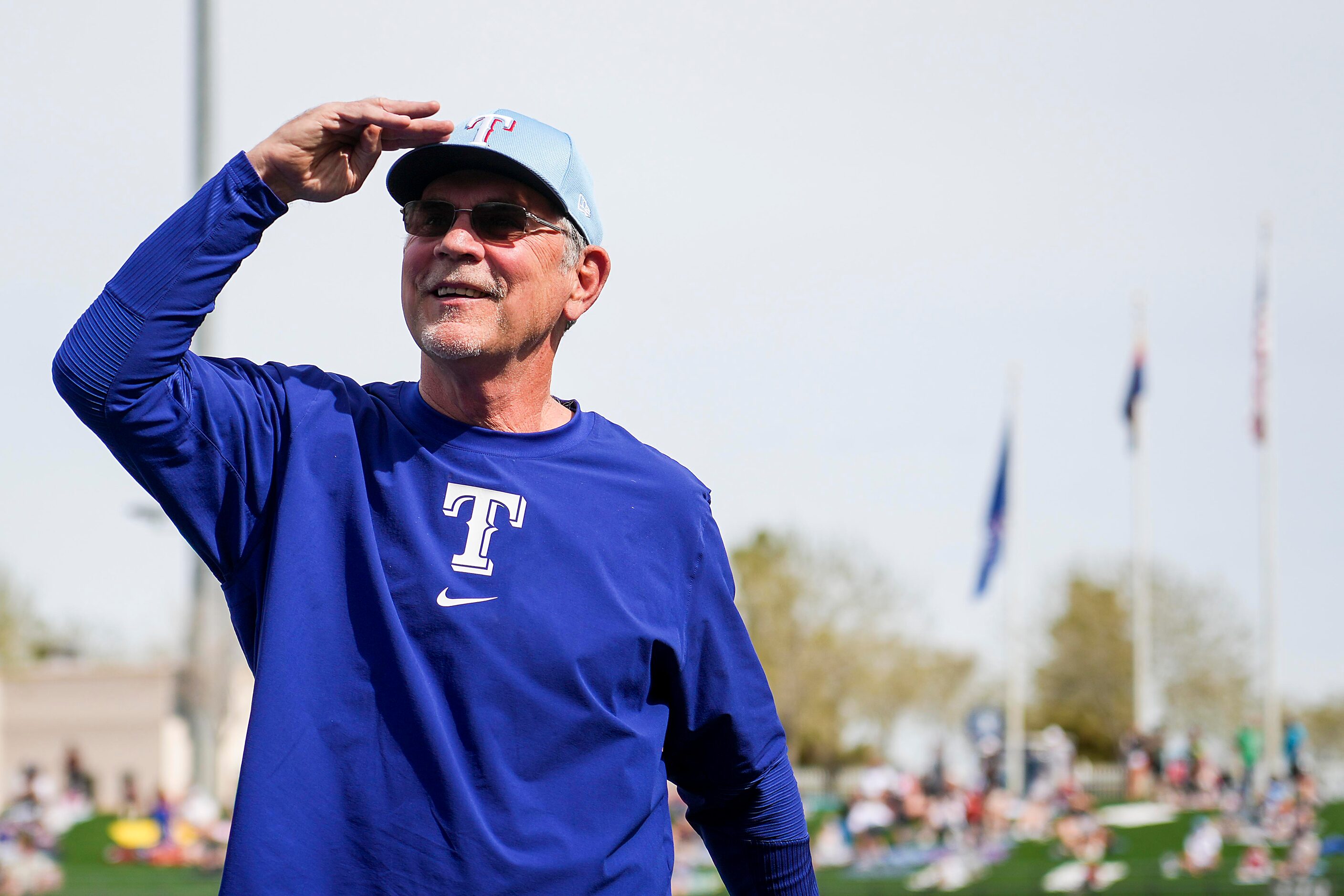 Texas Rangers manager Bruce Bochy salutes the crowd during ceremonies commemorating his...