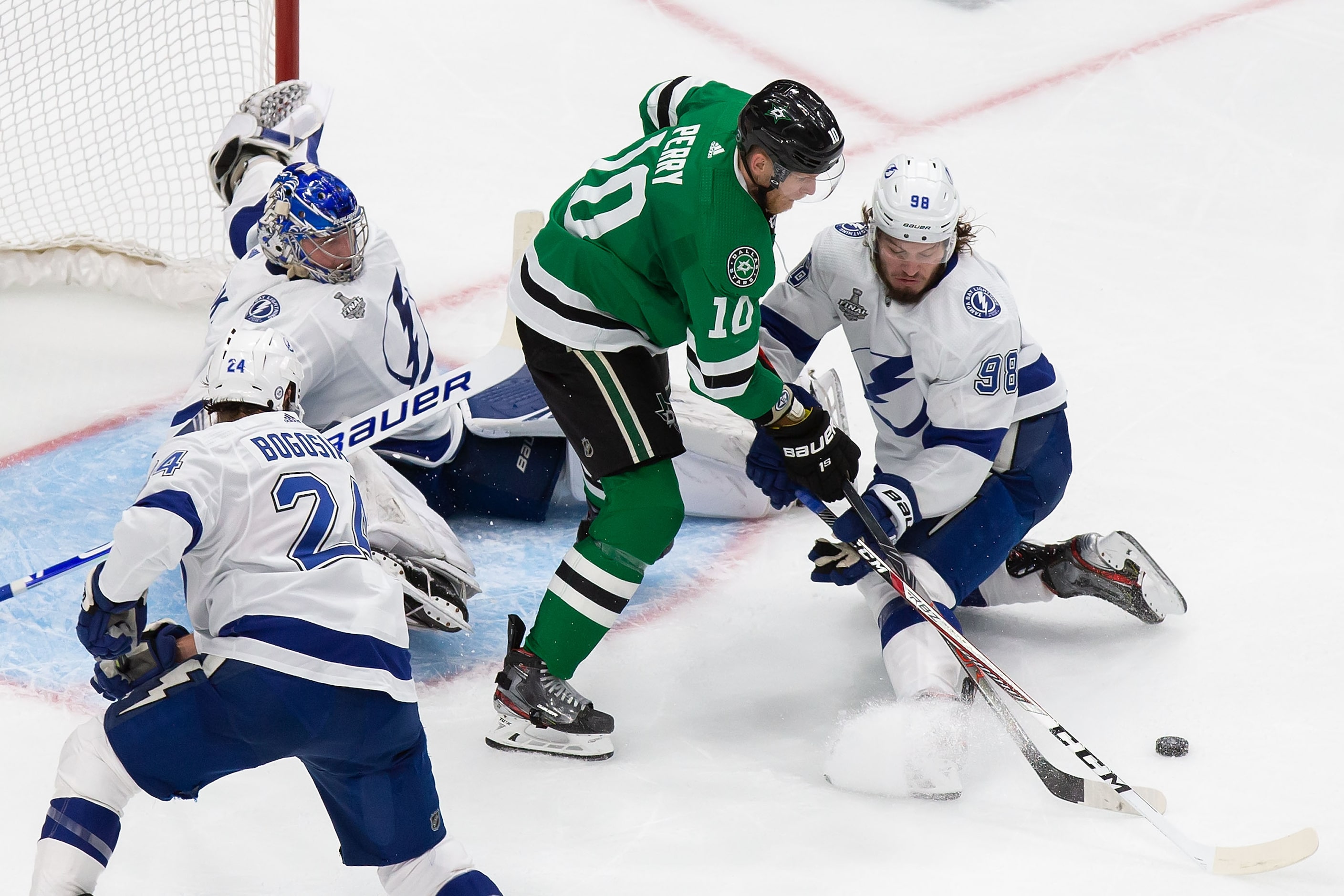 Corey Perry (10) of the Dallas Stars battles against goaltender Andrei Vasilevskiy (88) and...