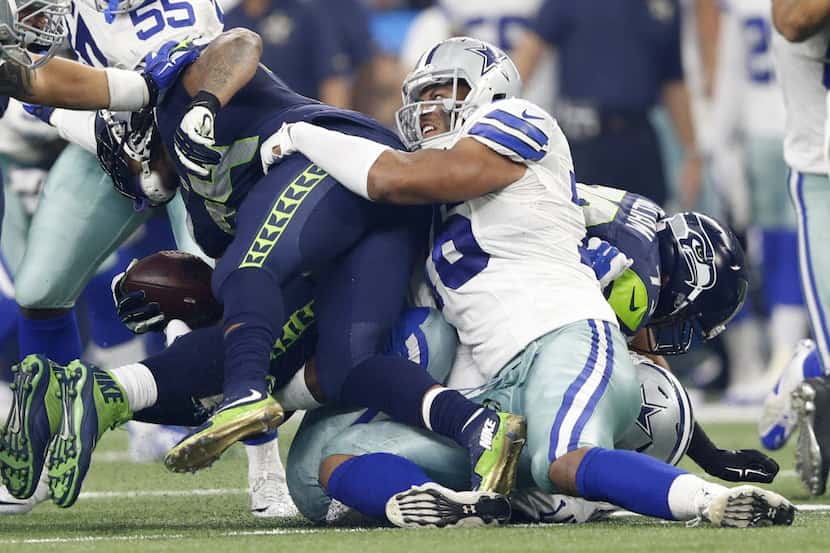 Dallas Cowboys defensive end Greg Hardy (76) tackles Seattle Seahawks running back Marshawn...