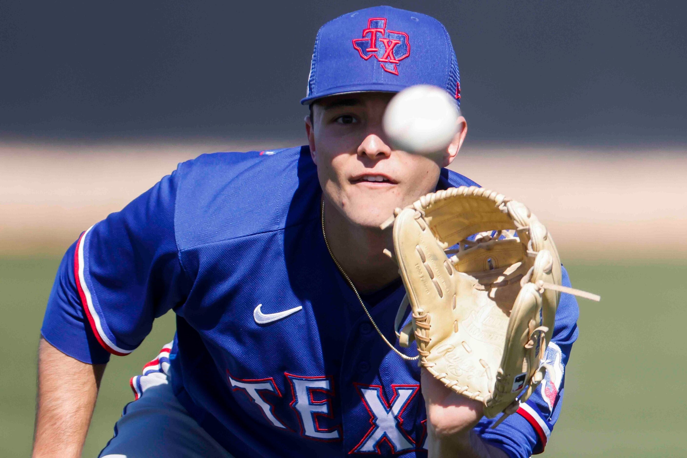 Texas Rangers right handed pitcher Jack Leiter keeps an eye on the ball during the first...