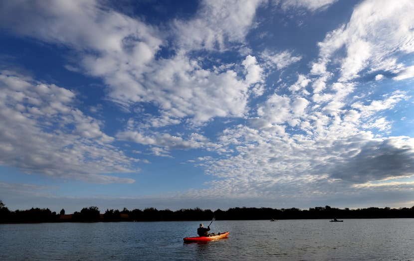 U.S. Army veteran Bobby Stephens paddles across the serene waters of a secluded private...