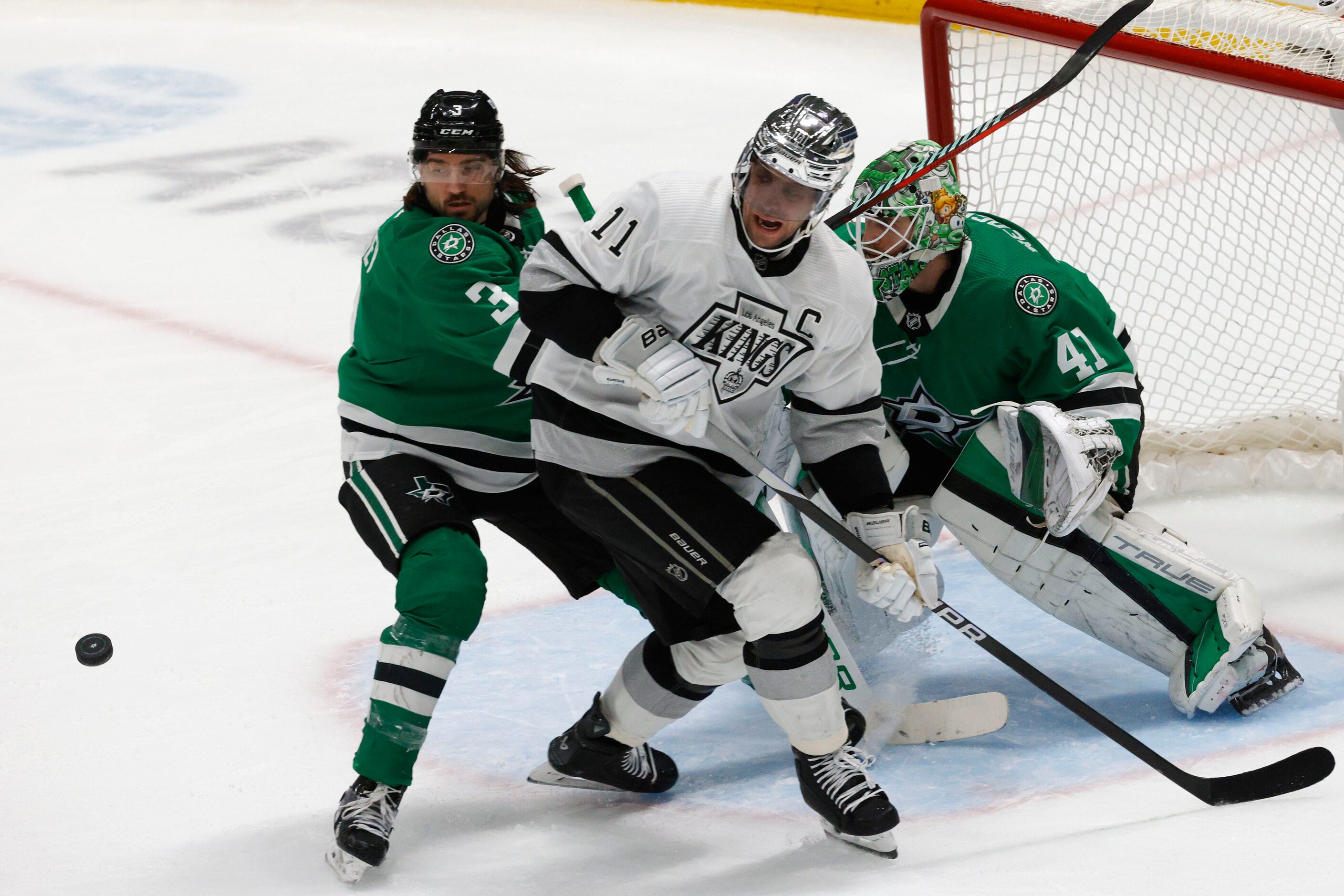 Dallas Stars defenseman Chris Tanev (3) and Los Angeles Kings center Anze Kopitar (11)...