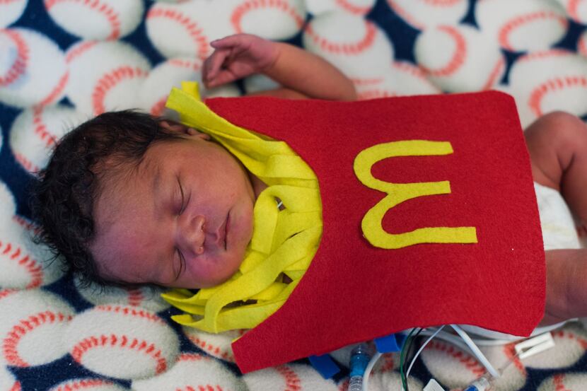 A baby in the NICU unit at Methodist Dallas in costume,  Nurses made felt costumes for the...