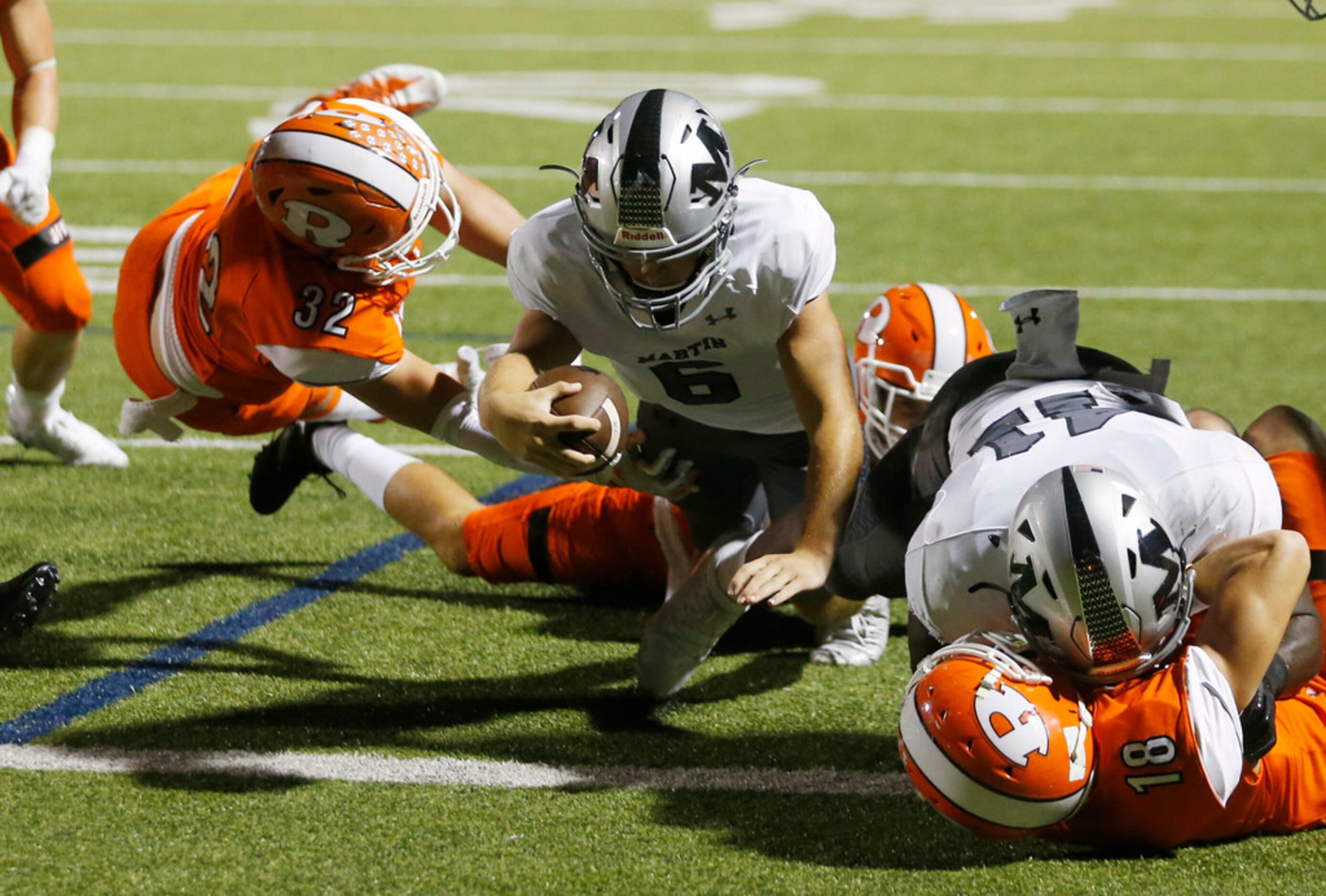 Arlington Martin's Zach Mundell (6) dives for a touchdown as Rockwall's Joseph Schaefer (32)...