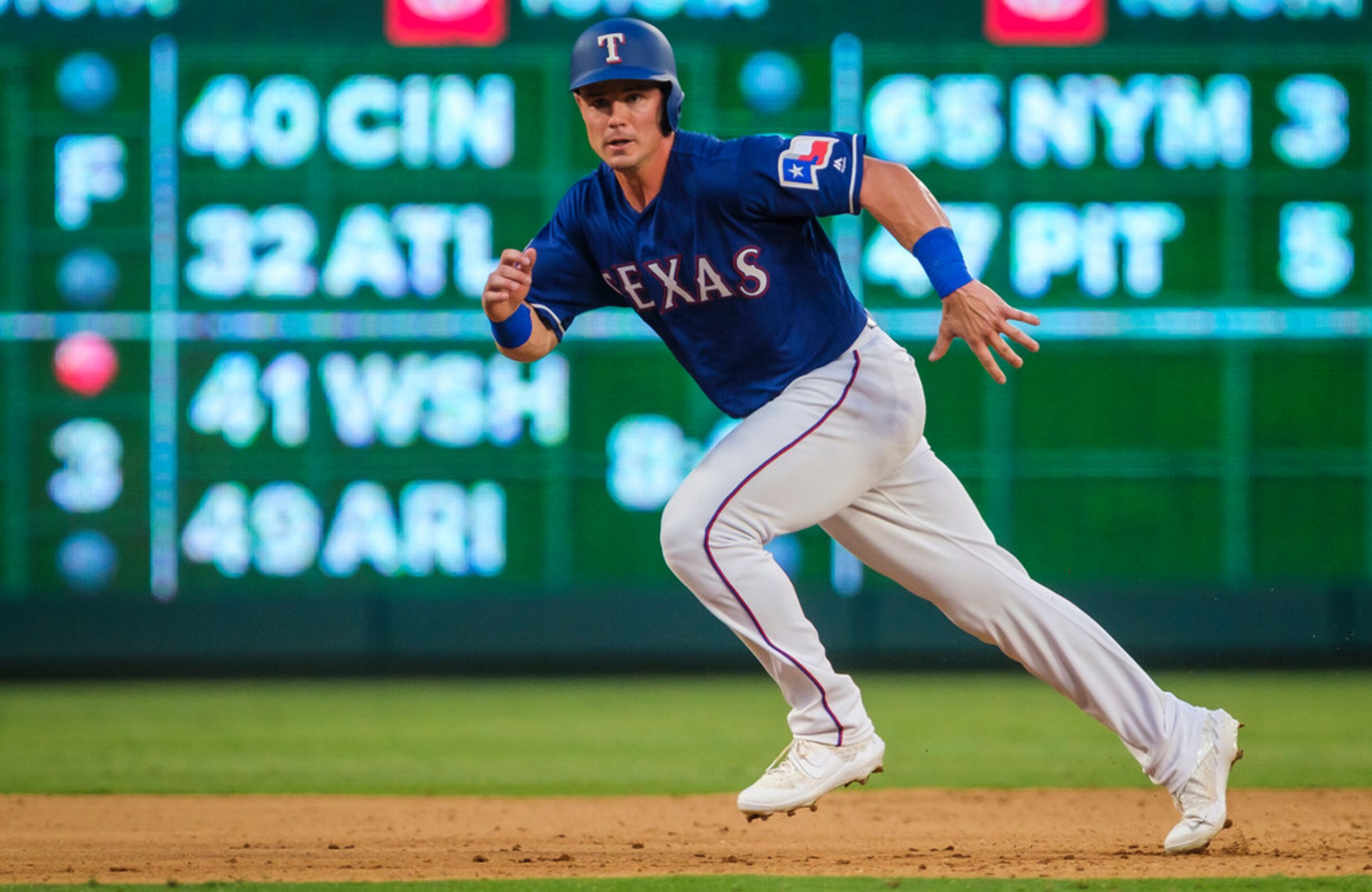 Texas Rangers outfielder Scott Heineman runs the bases after picking up his first major...