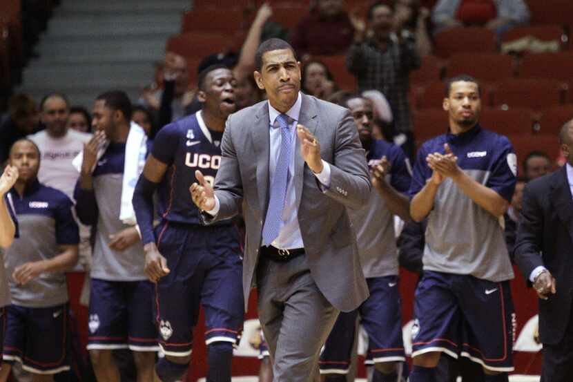Connecticut coach Kevin Ollie encourages his team during the second half of an NCAA college...