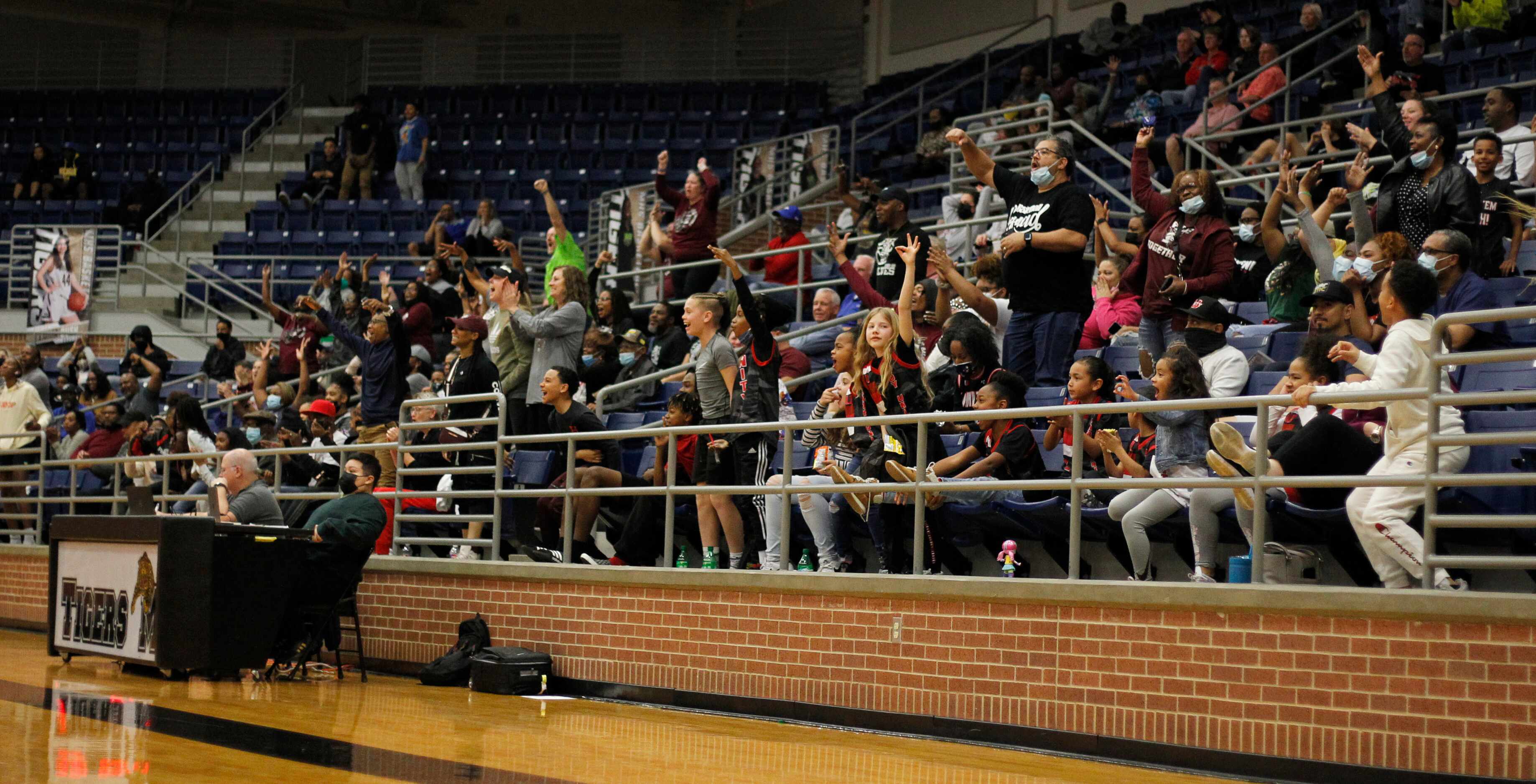Mansfield Timberview fans react after point guard Desiree Wooten (3) sinks a 3-pointer just...